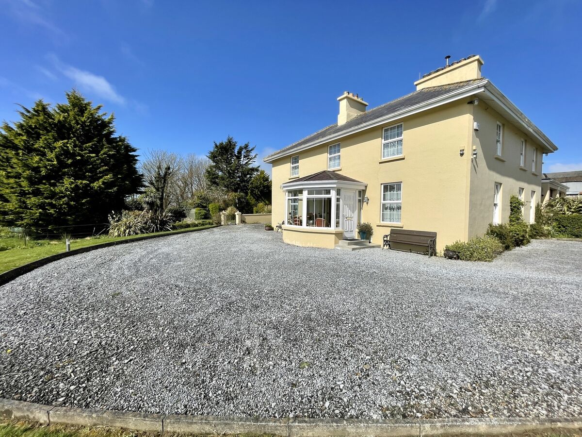 The entrance to Ballybroman House that has a kitchen, dining room, living room, toilet, utility room, bathroom, rear hallway, a circa 5m2 cellar and garage on the ground floor. The entrance to Ballybroman House that has a kitchen, dining room, living room, toilet, utility room, bathroom, rear hallway, a circa 5m2 cellar and garage on the ground floor.