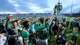 <p>To the victors go the spoils: Limerick's Jimmy Quilty celebrates with the trophy after the Treaty county claimed Munster U20 glory.</p>