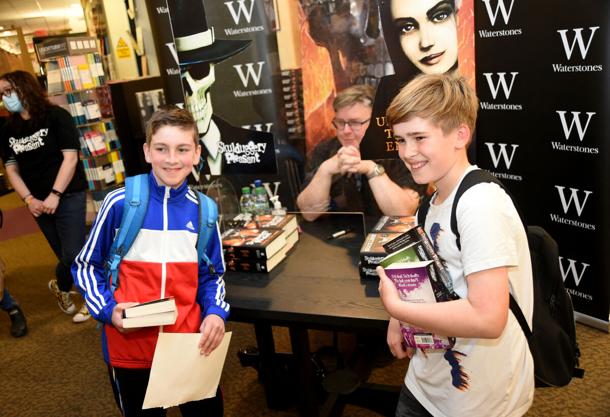 Skulduggery Pleasant book fans Adam Byrnes and Adam Calnan, from Frankfield with author Derek Landy Skulduggery Pleasant book fans Adam Byrnes and Adam Calnan, from Frankfield with author Derek Landy