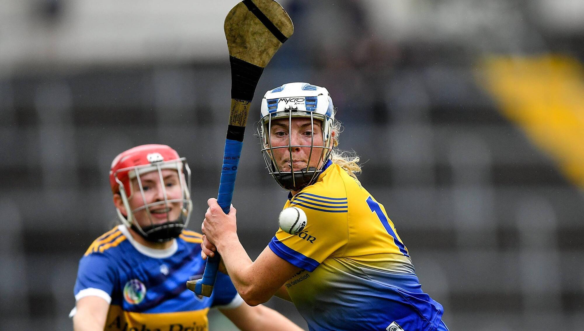 1 May 2022; Eimear Kelly of Clare is tackled by Aoife McGrath of Tipperary during the Munster Senior Camogie Championship Semi-Final match between Clare and Tipperary at FBD Semple Stadium in Thurles, Tipperary. Photo by Ray McManus/Sportsfile