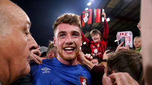 <p>Bournemouth goalkeeper Mark Travers celebrates winning promotion to the Premier League. Photo credit: John Walton/PA Wire.</p>