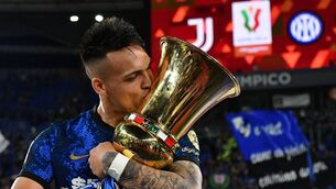 <p>TOPSHOT - Inter Milan's Argentine forward Lautaro Martinez kisses the winner's trophy after Inter won the Italian Cup (Coppa Italia) final football match between Juventus. (Photo by ISABELLA BONOTTO/AFP via Getty Images)</p>