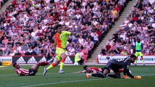 <p>Cut off the old block: Nottingham Forest's Brennan Johnson scores his side's second goal of the game during the Sky Bet Championship play-off semi-final, first leg match at Bramall Lane, Sheffield. </p>
