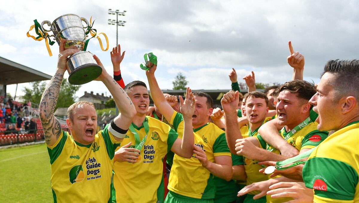 SILVER SUCCESS: Rockmount captain Ken Hoey, left, lifts the Pat O'Brien Intermediate Challenge Cup as he celebrates his teammates at Turner's Cross. 