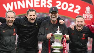 <p>Liverpool's (left-right) Assistant First Team Goal Keeping coach Jack Robinson, First Team Goalkeeping coach John Achterberg , manager Jurgen Klopp and assistant manager Pepijn Lijnders pose with the trophy after the Emirates FA Cup final at Wembley Stadium. Photo credit: Nick Potts/PA Wire.</p>