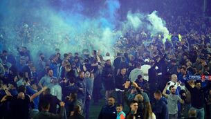 <p>Everton fans celebrate on the pitch. Peter Byrne/PA Wire.</p>