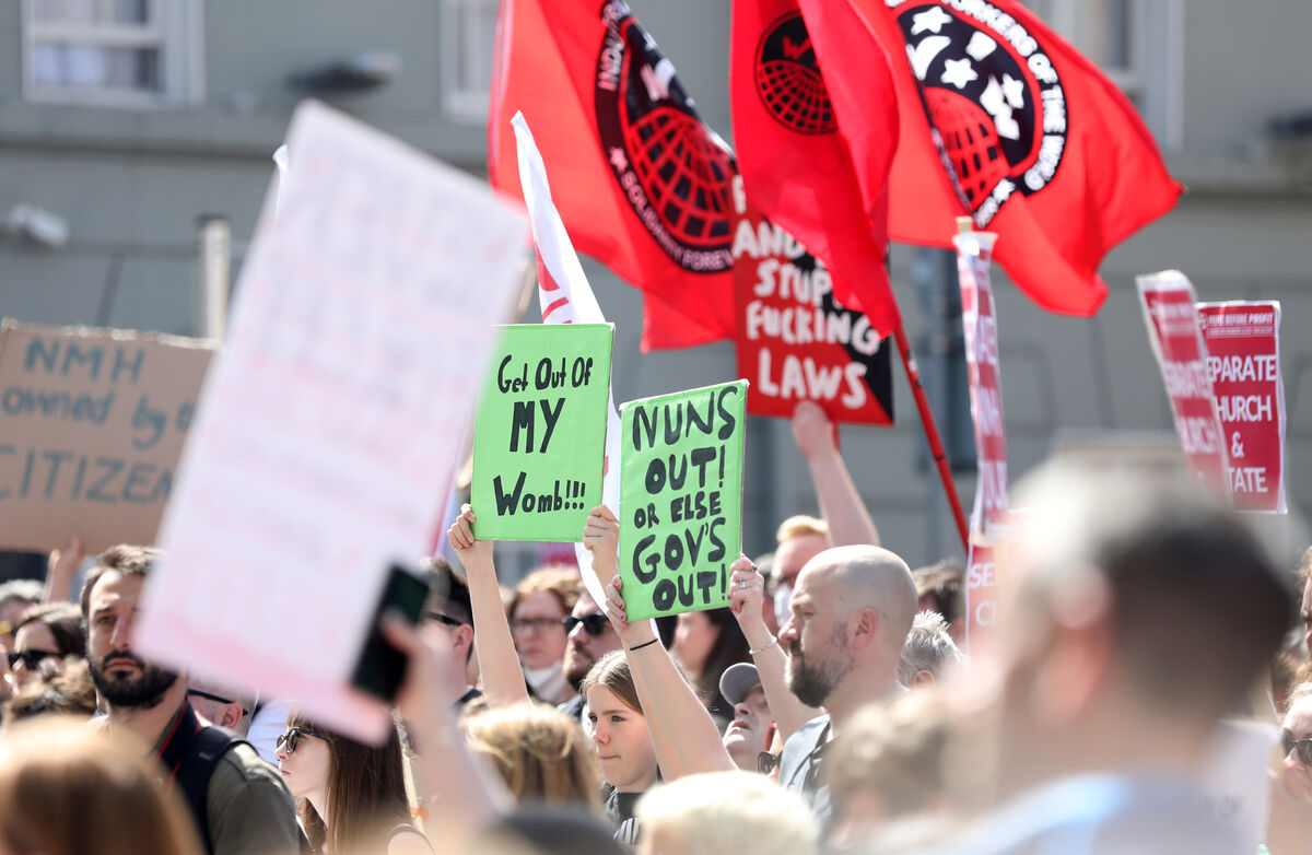A large crowd of protesters carrying placards saying separate Church and State at a National Maternity Hospital protest rally outside the Dail (Leinster House). A large crowd of protesters carrying placards saying separate Church and State at a National Maternity Hospital protest rally outside the Dail (Leinster House).