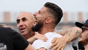 <p>AC Milan's French forward Olivier Giroud celebrates after AC Milan won the Italian Serie A football match between Sassuolo and AC Milan, securing the "Scudetto" championship on May 22, 2022 at the Mapei - Citta del Tricolore stadium in Sassuolo. (Photo by FILIPPO MONTEFORTE/AFP via Getty Images)</p>
