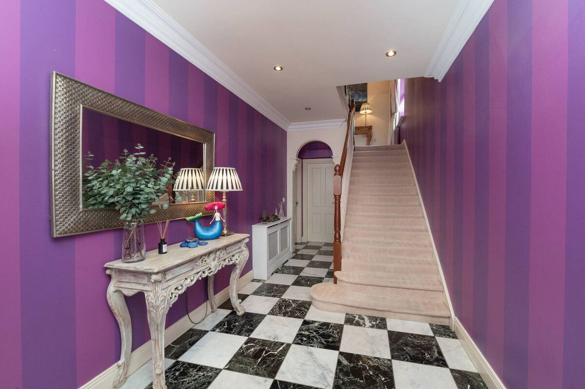 The bathroom was pushed back behind the stairs to open up the hall 