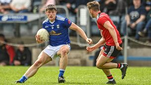 <p>28 May 2022; James Smith of Cavan in action against Adam Lynch of Down during the Tailteann Cup Round 1 match between Cavan and Down at Kingspan Breffni in Cavan. Photo by Oliver McVeigh/Sportsfile</p>