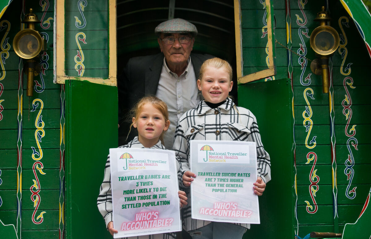 James Collins from Finglas with Elsie Kimberlin, 6, and Ayla Kimberlin, 9, from Stourport-on-Severn, England, at the Traveller protest outside Leinster House. Picture: Gareth Chaney/Collins