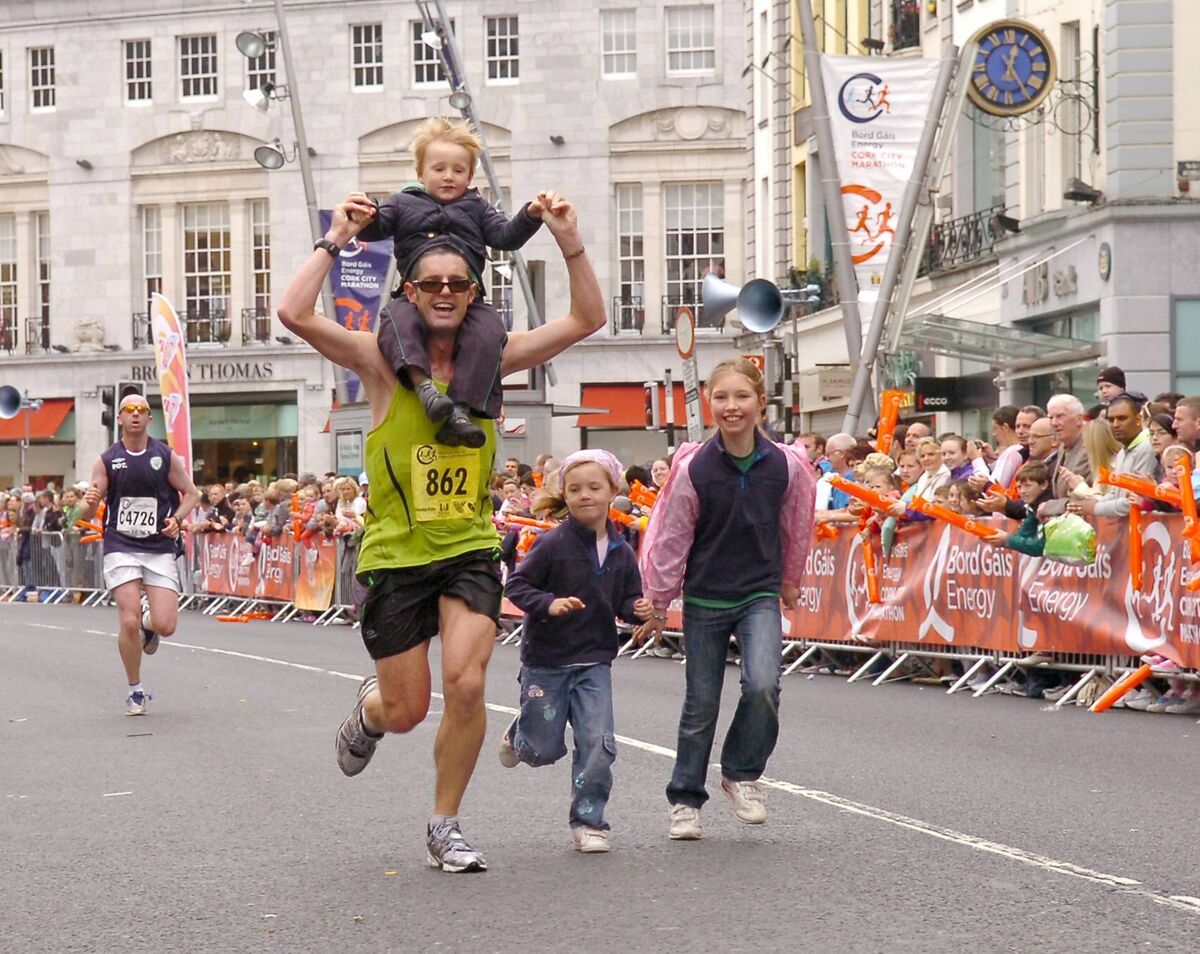 Richard Cronin, Ballintemple, getting and giving some family support from young Tom, Hannah and Pia, as he comes up to the finishing line during the 2011 Cork City Marathon. Picture: Richard Mills Richard Cronin, Ballintemple, getting and giving some family support from young Tom, Hannah and Pia, as he comes up to the finishing line during the 2011 Cork City Marathon. Picture: Richard Mills