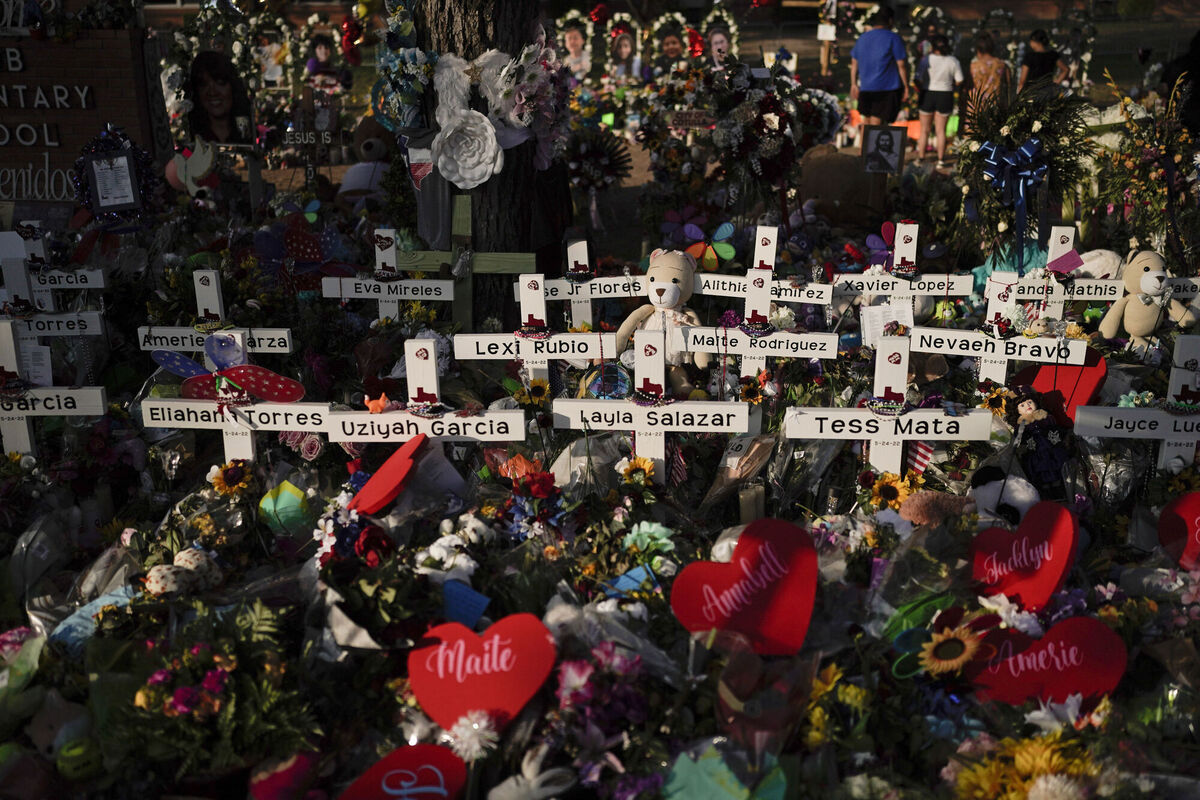 Flowers are piled around crosses with the names of the victims killed in the shooting. Picture: AP Photo/Jae C. Hong