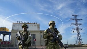 Russian troops guard an entrance of the Kakhovka Hydroelectric Station, a run-of-the-river power plant on the Dnieper River in Kherson region, southern Ukraine (AP)