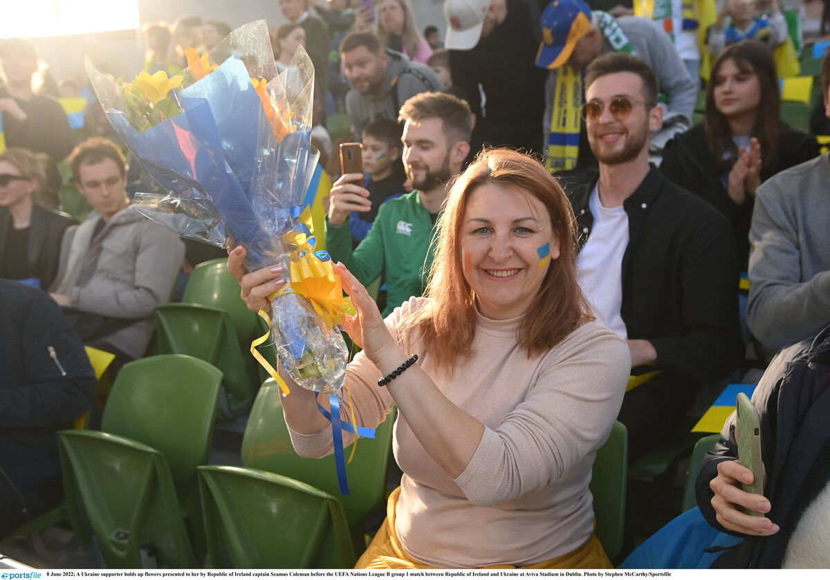 A Ukraine supporter holds up flowers presented to her by Republic of Ireland captain Seamus Coleman before the UEFA Nations League B group 1 match between Republic of Ireland and Ukraine at Aviva Stadium in Dublin. Picture: Stephen McCarthy/Sportsfile