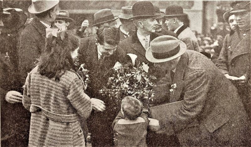 Michael Collins receiving a bouquet from a child during a visit to Cork City in 1922. The picture features on the cover of the Cork City Libraries 2022 calendar.