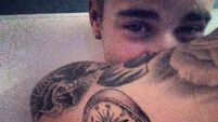 Bieber shows off new ink