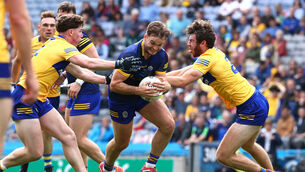 <p>Roscommon's Ultan Harney is tackled by Cillian Rouine and Manus Doherty of Clare. Both defenders were also comfortable carrying the ball out. </p>