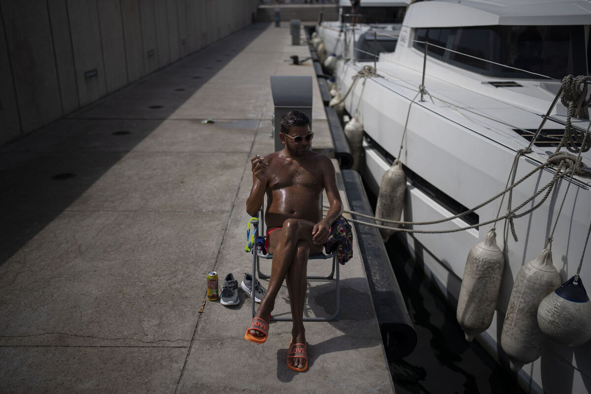 A man sunbathes during a heat wave in Marseille, southern France on Wednesday. Picture: AP Photo/Daniel Cole