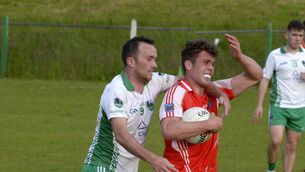 <p> Tight tussle: Beara's Finbar Finnear being tackled by Evan O'Sullivan for Muskerry. Pic: Denis Boyle</p>