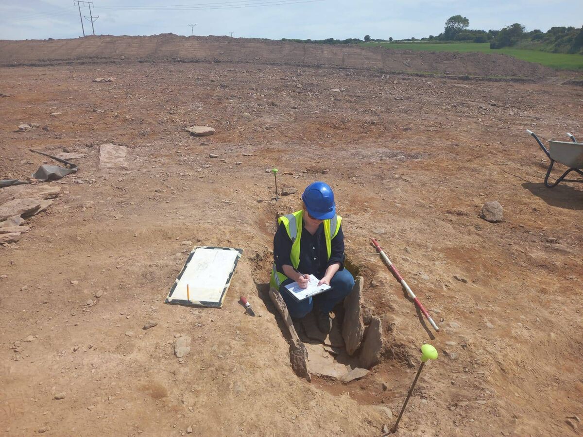 Niamh Daly, freelance osteoarchaeologist onsite recording a cist grave. Cist graves were a funerary practice in the Irish Bronze Age.  