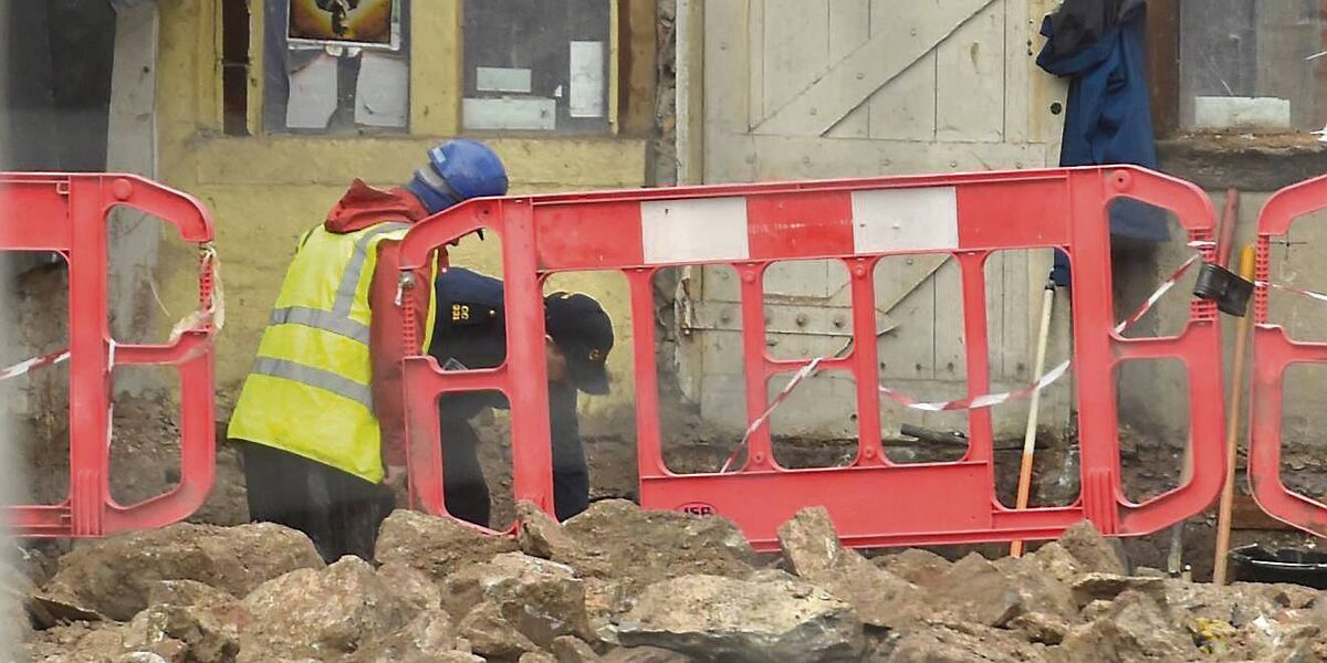 A garda with a workman on the site of the former Nancy Spain's pub on Barrack Street. Picture: Dan Linehan