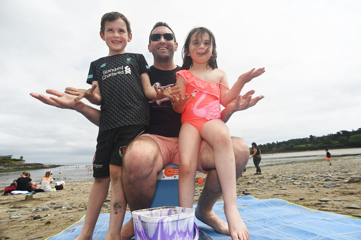 Grey skies or blue , Where's the sunshine as Owen McCarthy and his children Aoife and Darragh from Douglas , enjoy the warm but overcast skies at Fountainstown beach in County Cork last week. Grey skies or blue , Where's the sunshine as Owen McCarthy and his children Aoife and Darragh from Douglas , enjoy the warm but overcast skies at Fountainstown beach in County Cork last week.