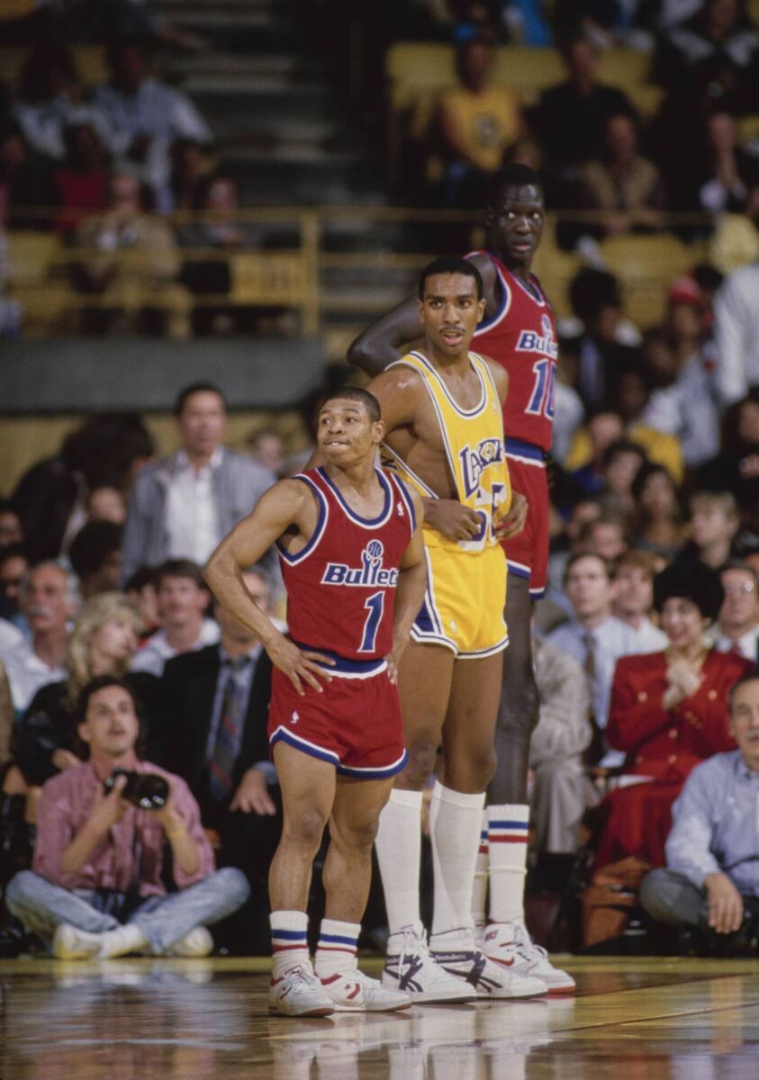Standign alongside the Lakers' Billy Thompson and Manute Bol at The Forum arena in Inglewood. Standign alongside the Lakers' Billy Thompson and Manute Bol at The Forum arena in Inglewood.