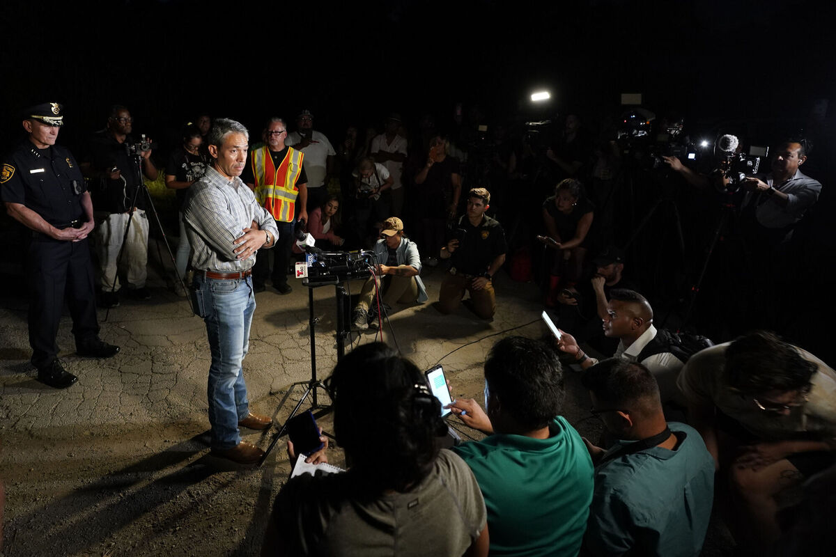 San Antonio Mayor Ron Nirenberg with San Antonio Police Chief William McManus, left, brief media and others at the scene where they said dozens of people have been found dead and multiple others were taken to hospitals with heat-related illnesses after a semitrailer containing suspected migrants was found, Monday, June 27, 2022, in San Antonio. Picture: AP Photo/Eric Gay San Antonio Mayor Ron Nirenberg with San Antonio Police Chief William McManus, left, brief media and others at the scene where they said dozens of people have been found dead and multiple others were taken to hospitals with heat-related illnesses after a semitrailer containing suspected migrants was found, Monday, June 27, 2022, in San Antonio. Picture: AP Photo/Eric Gay
