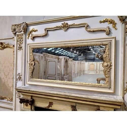 The stylish French mantelpiece (note quantity of panels reflected in the mirror.