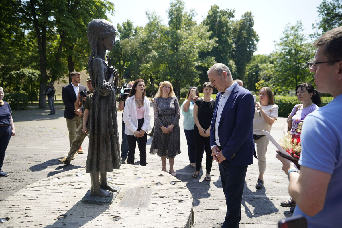 The Taoiseach and his entourage observe a minute silence at the foot of the Bitter Memory of Childhood statue, which commemorates the victims of the Great Famine in 1932-33, at the Holodomor Victims Memorial in Kyiv. Picture: Niall Carson/PA Wire