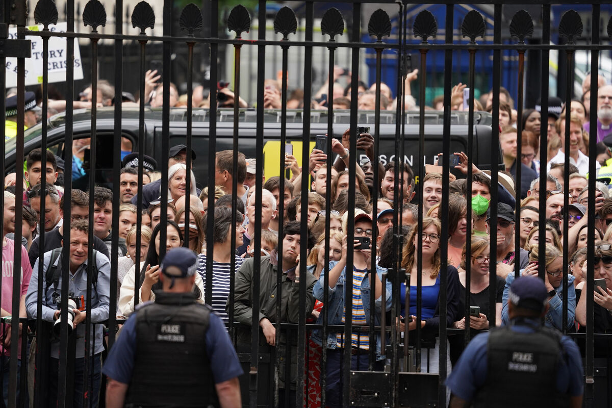 Members of the public outside the gates of Downing Street on Thursday as Boris Johnson  formally resigns.