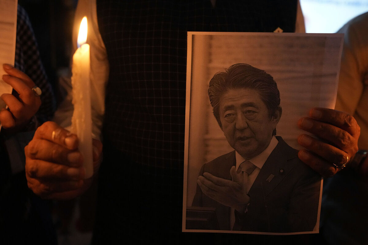 An Indian man holds a candle and photo of Japan's former Prime Minister Shinzo Abe during a prayer meeting to pay their respects at Japan Information and Study Centre in Ahmedabad, India. Picture: AP Photo/Ajit Solanki An Indian man holds a candle and photo of Japan's former Prime Minister Shinzo Abe during a prayer meeting to pay their respects at Japan Information and Study Centre in Ahmedabad, India. Picture: AP Photo/Ajit Solanki