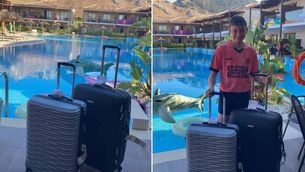 <p>Shane Mee, 12, with the luggage once it finally made the journey to Greece. Picture: Amanda Mee</p>