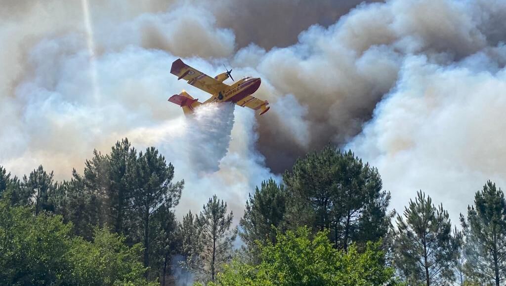 This photo provided by the fire brigade of the Gironde region (SDIS 33) shows a Canadair plane fighting wildfire near La Teste-de-Buch, southwestern France on Saturday