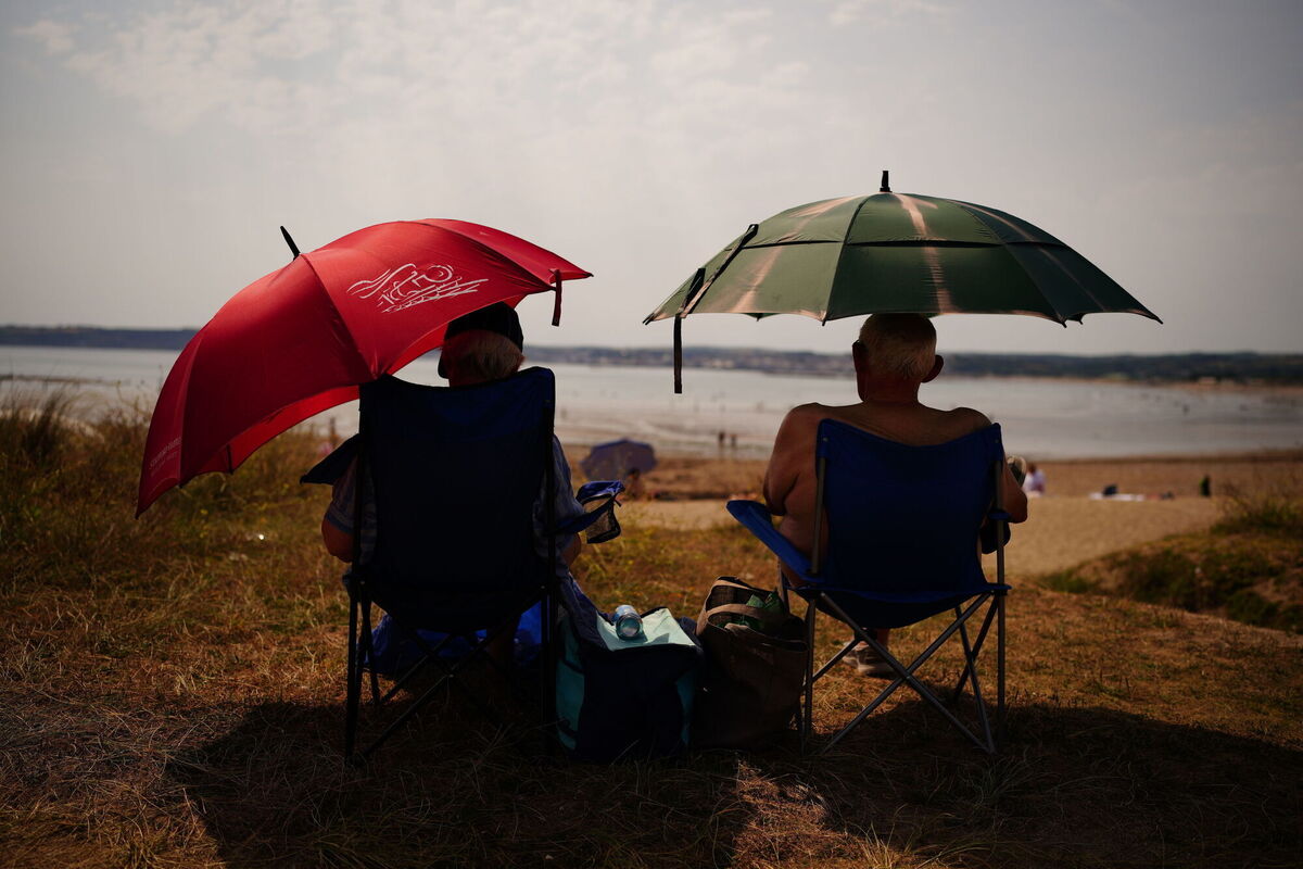 People should try to keep in the shade when outdoors and ensure that they are well hydrated. Picture: Ben Birchall/PA Wire