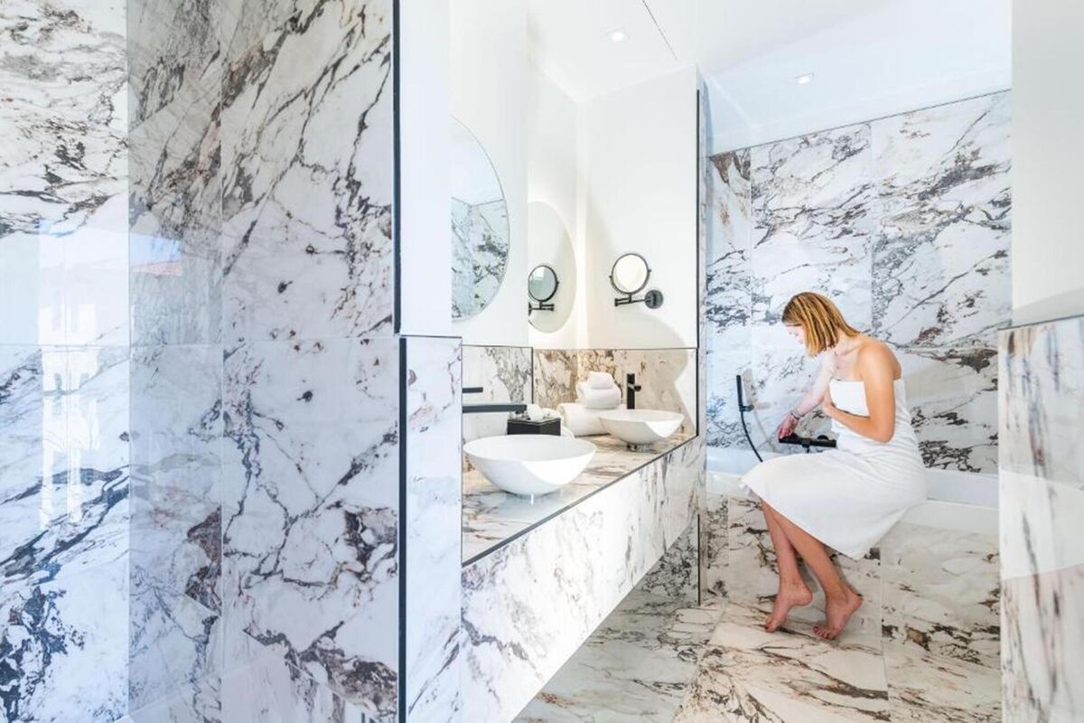 A bathroom in stunning Carrara marble at the Boutique Hotel Nice Cote DíAzur, from 189 for two, per night with booking.com. A suitable porcelain tile could deliver this French flash.
