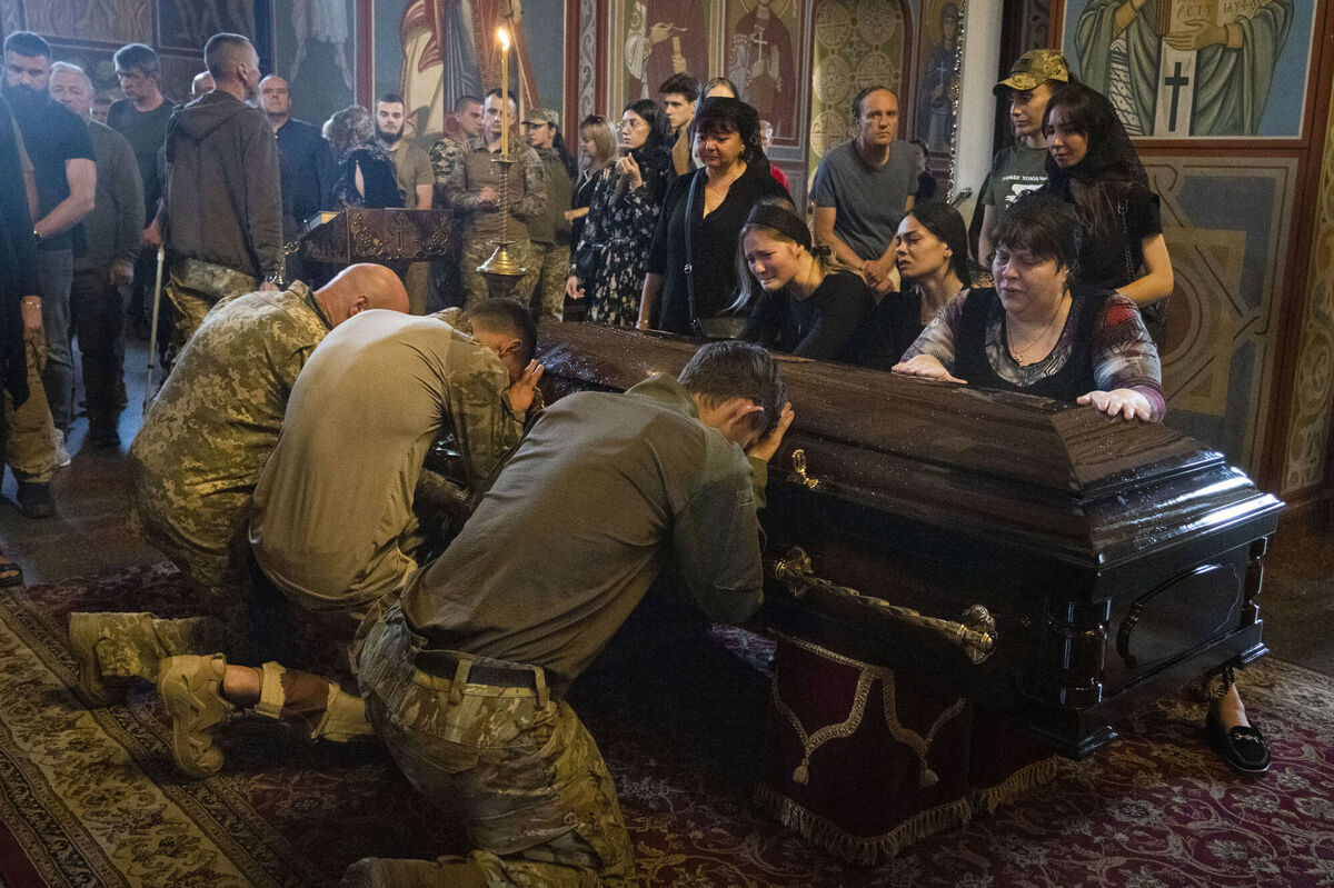 Soldiers pay the last respect at the coffin of a soldier, codename Fanat, killed by the Russian troops in a battle, during a ceremony at St Michael Cathedral in Kyiv, Ukraine Picture: AP Photo/Efrem Lukatsky