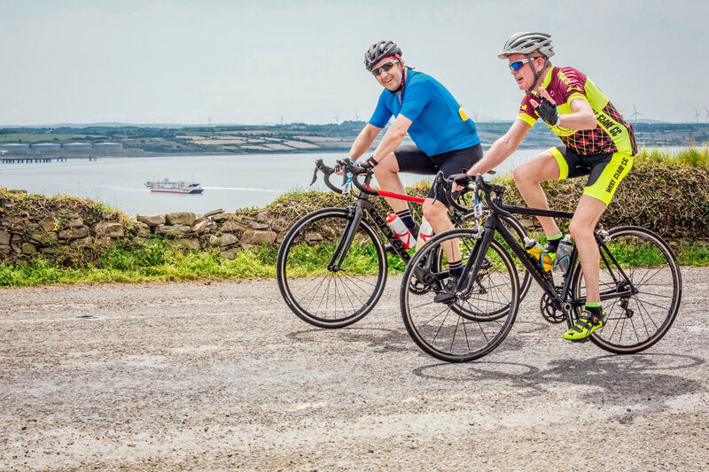 Some 2,500 cyclists make their way past Kilimer as the ferry comes in from Tarbert 