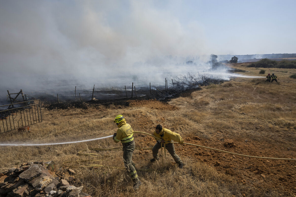 Firefighters work at the scene of a wildfire in Tabara, north-west Spain, last week. Picture: AP Photo/Bernat Armangue