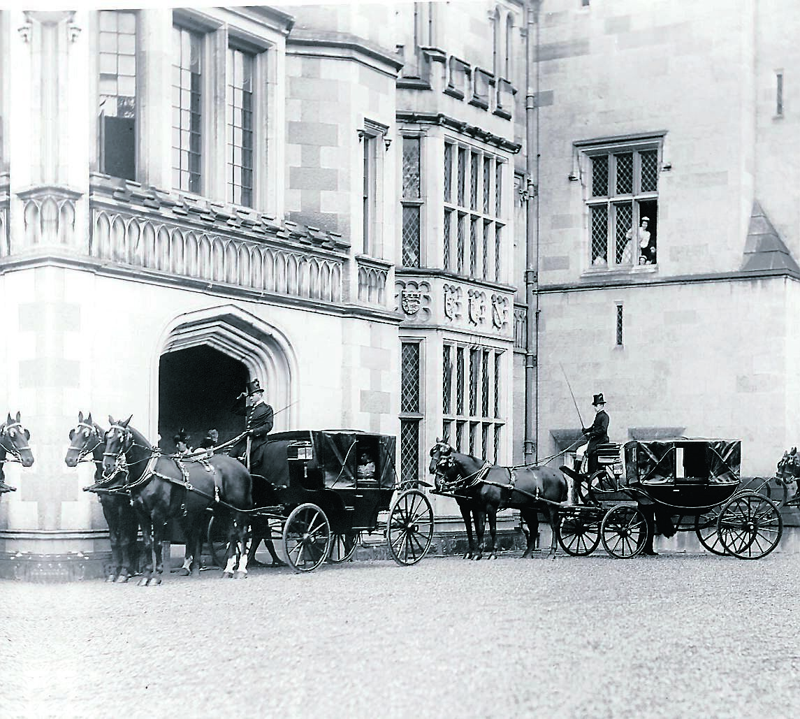 A maid leans out through a first floor window to get a glimpse of the royal visitors below. This image is possibly of the departure of the Duke and Duchess of York after visiting the Dunravens in 1897. Lord Dunraven had a Republican ghillie who kept Adare Manor safe during the burnings of other big houses. 	Picture: National Library of Ireland
                    