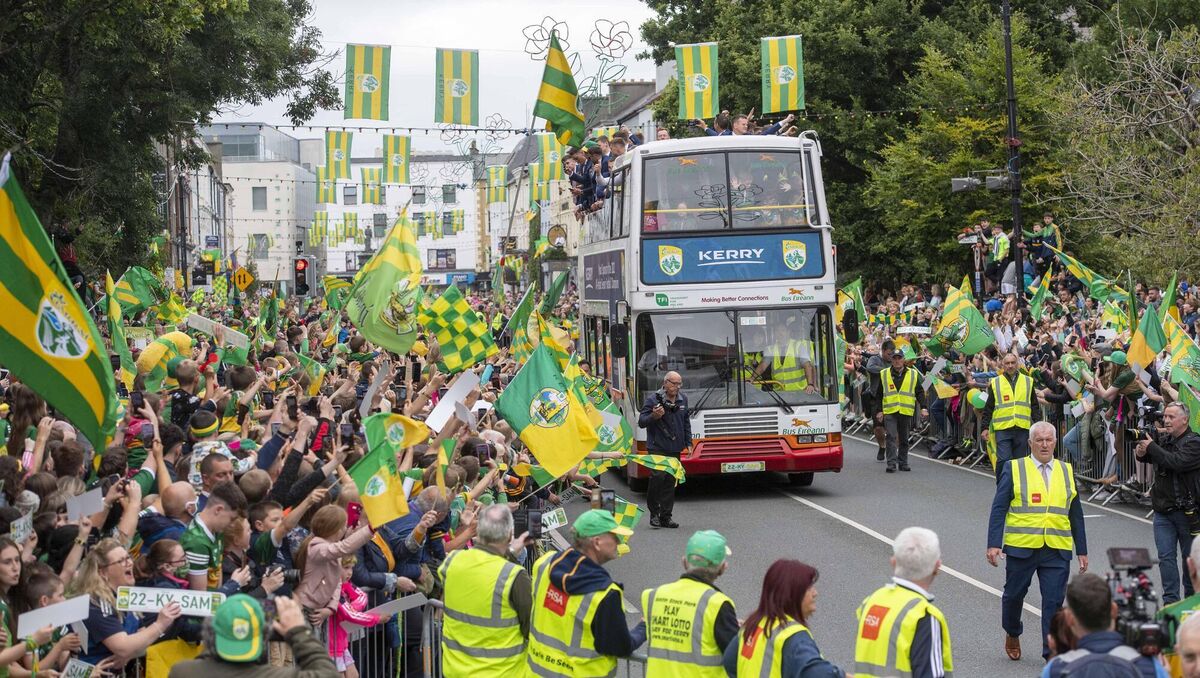 Waving from their open-top bus, the All Ireland winning Kerry Football team were surrounded by thousands of delighted GAA fans on Denny St in Tralee on Monday evening. Picture: Domnick Walsh