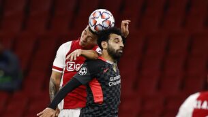 <p>SPIRIT: Lisandro Martinez, left, wins a header against Liverpool’s Mohamed Salah. Pic: PA via ANP</p>