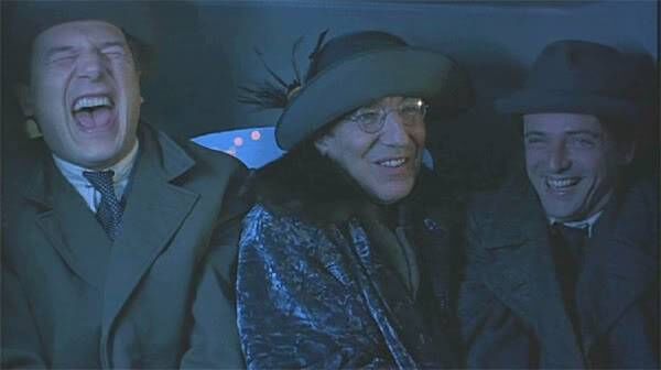 Alan Rickman as Eamon de Valera in the 1996 film Michael Collins, having escaped from Lincoln Prison dressed as a woman, beside Michael Collins (left), played by Liam Neeson, and Harry Boland, played by Aidan Quinn Alan Rickman as Eamon de Valera in the 1996 film Michael Collins, having escaped from Lincoln Prison dressed as a woman, beside Michael Collins (left), played by Liam Neeson, and Harry Boland, played by Aidan Quinn