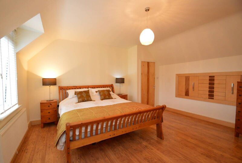 Main bedroom with pull-out storage units in the eaves Main bedroom with pull-out storage units in the eaves