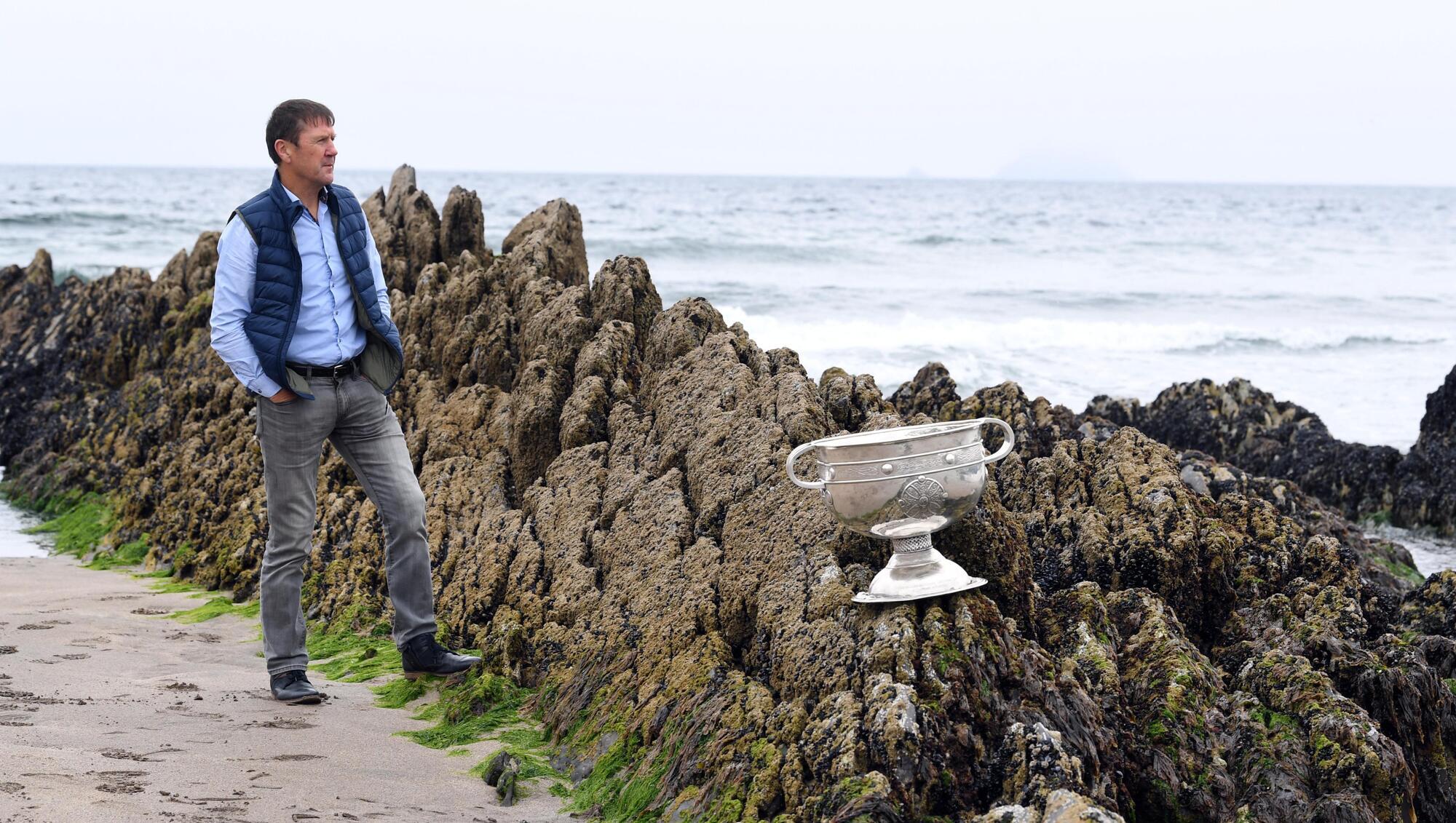 HOLY GRAIL: Kerry team manager Jack O'Connor, with the Kingdom's Holy Grail that is the Sam Maguire Cup pictured on St. Finan's Beach in South Kerry on Friday. 