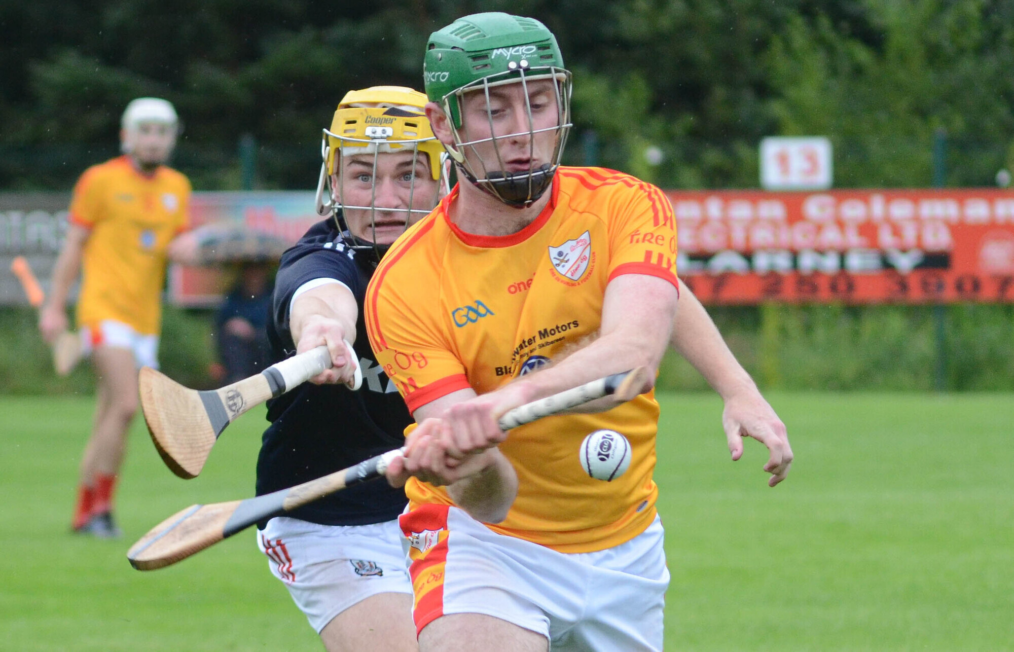 HOOKED: Éire Og's John Mullins attempts to clear upfield under pressure from Watergrasshill's Sean Desmond. 
