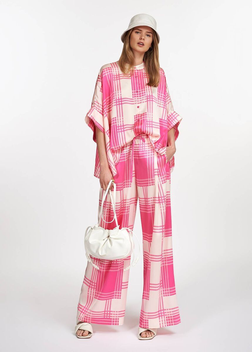 Off-white oversized shirt with pink check motif, €165; off-white wide leg pants with pink check motif, €185, Essential Antwerp 