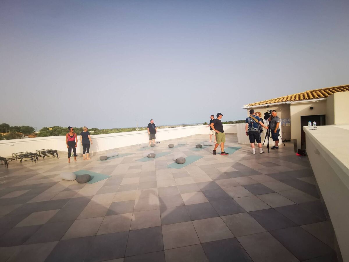 Dr Eva and Joyce the yoga teacher setting up to film a yoga class on the roof top