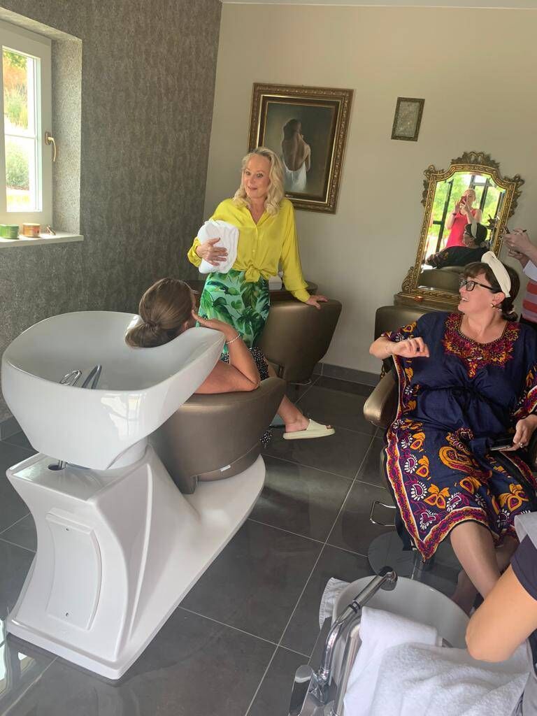 Dr Eva trying out her hairdressing skills on Andrea at Solar Alvura